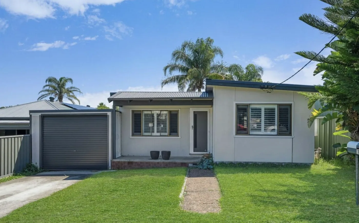 Exterior of the Argenton ILO home with a front garden and garage