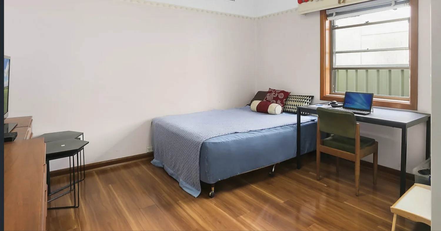 Furnished private bedroom with timber floors at the North Parramatta home